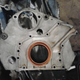 Block side of rear plate. This plate houses the rear main seal, provides an oil drainback channel from the cylinder head, and gives the starter something to bolt to.